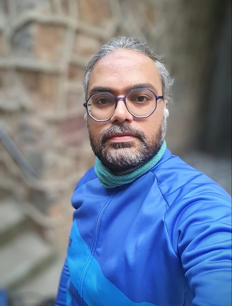 Portrait in a blue cycling jersey after a ride.