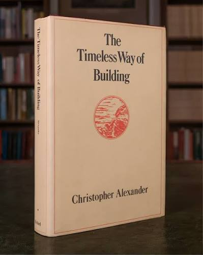 The Timeless Way of Building by Christopher Alexander — cream hardcover with a red circular drawing.
